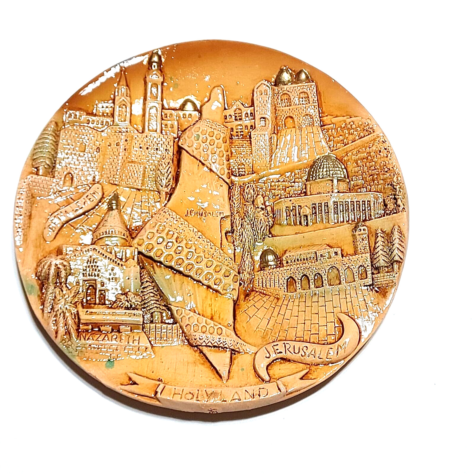 A ceramic masterpiece hung on the wall with the Holy Land engraved on it, handcr