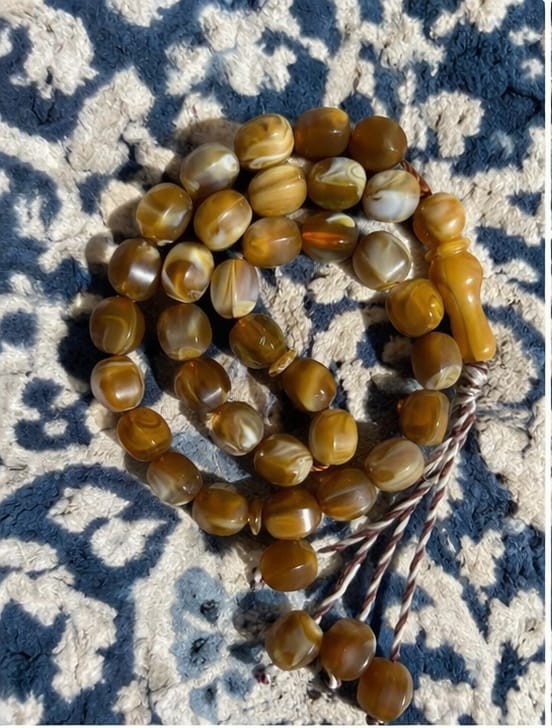 A classic elegant 33-bead tasbih featuring smooth polished beads in a warm Brown