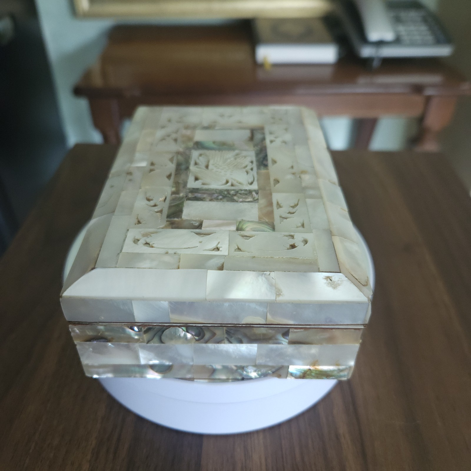 A traditional handmade shell box containing an elegant shell Quran.