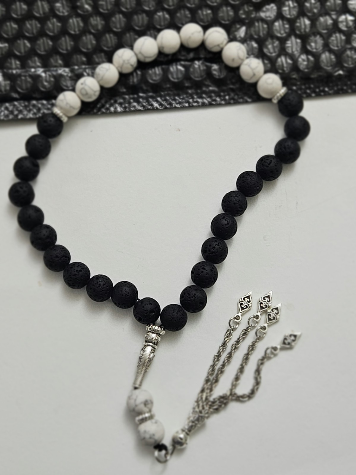 A distinctive and elegant rosary of value made from lava stone and natural white